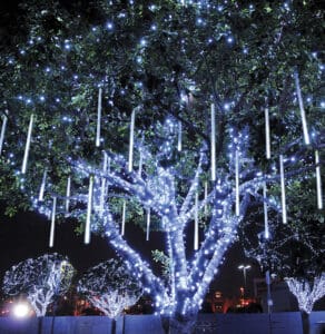 Tree wrapped in white Christmas lights with hanging icicles by Christmas Decor in Boynton Beach