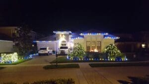 Blue and white Christmas light display on home by Christmas Decor in Boynton Beach
