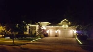 Warm white roofline and driveway Christmas lights by Christmas Decor in Boynton Beach
