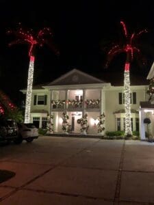 Luxury home with palm tree Christmas lighting by Christmas Decor in Boynton Beach